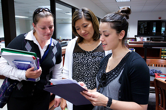 Students look at papers together