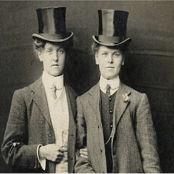 Black and White image of Two Men in Top Hats standing side by side 