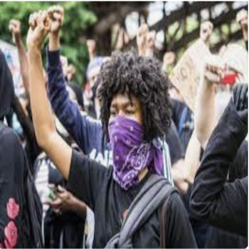Woman at a Rally Wearing a Purple Mask