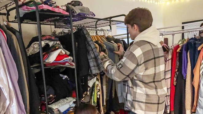Student browses rack in RWU's new thrift center.