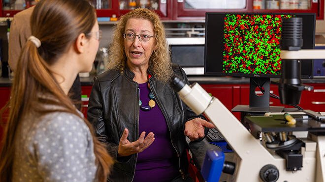 Professor Avelina Espinosa speaks with a student.