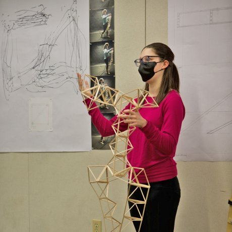 A student presenting her model to the studio