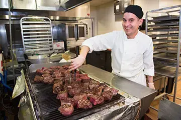 Chef cooking steak.