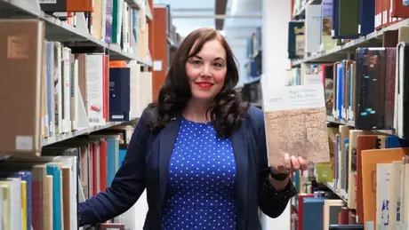 RWU History Professor Charlotte Carrington-Farmer holds her new book.