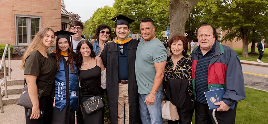 Graduates pose with their families at commencement