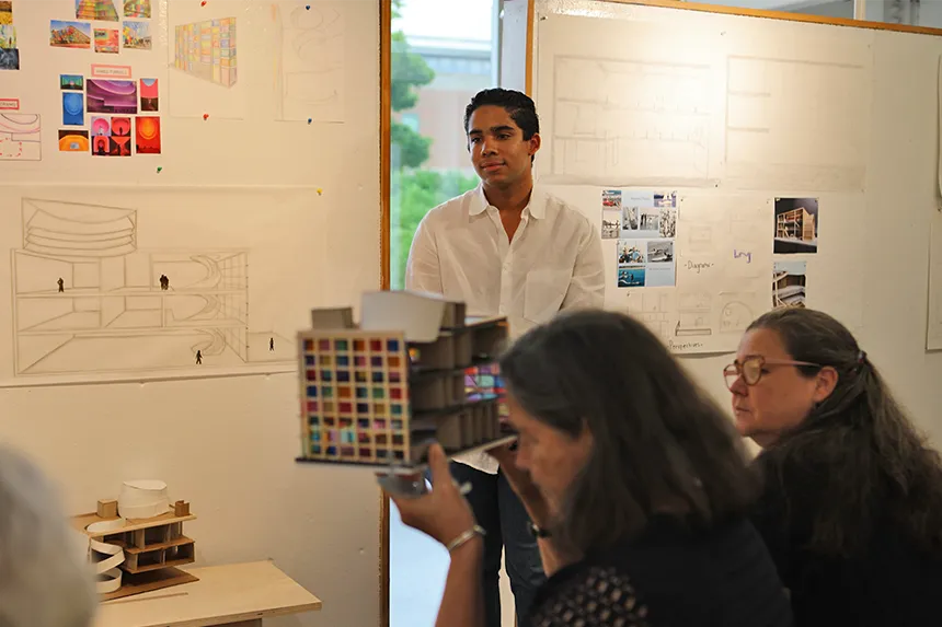 Julia Bernert looking into a student model while presenting