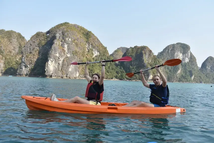 Kayakers raise their arms to celerbate in Vietnam