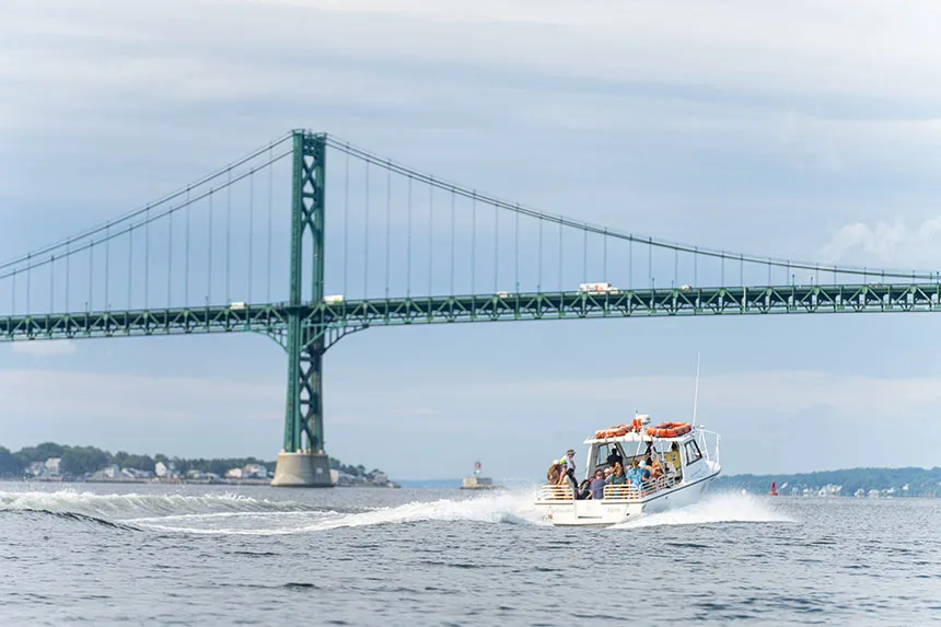 An image of the InVinceble Spirit research vessel going under the Mount Hope Bridge.