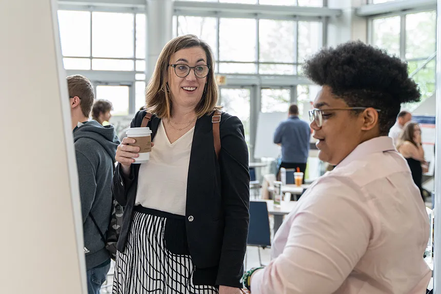 Provost Everett speaks with a student at SASH.