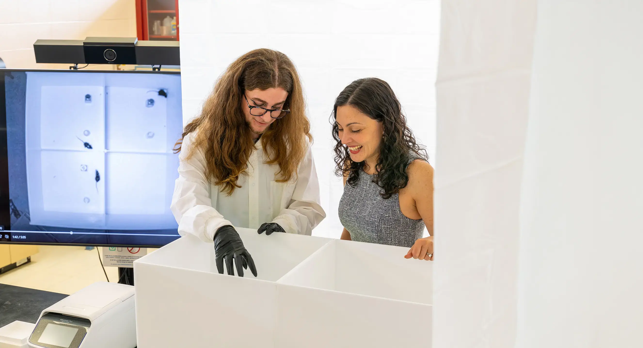 A professor and student work on research in a lab
