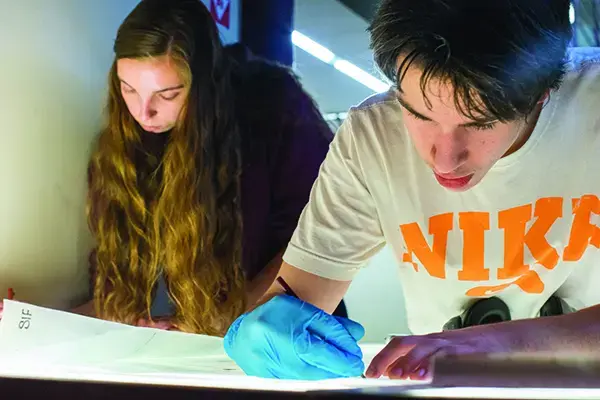 Two criminal justice students working on a project