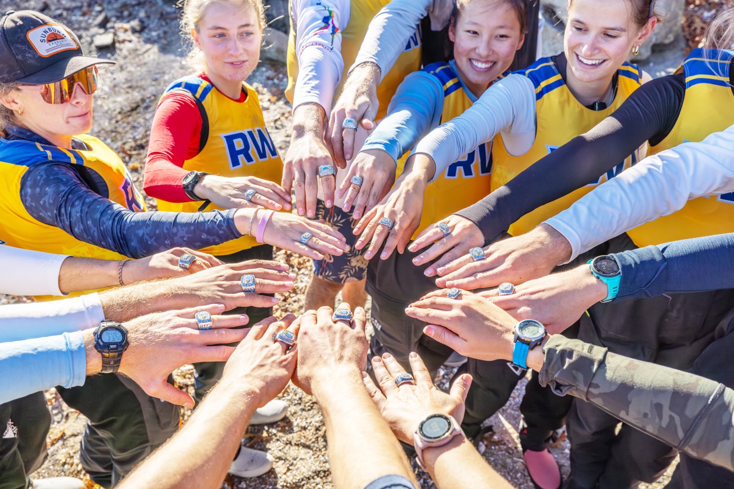 Members of the RWU Sailing team display their national championship rings.