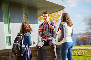Students talking in front of a hall