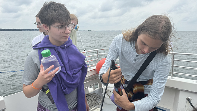 Two students on the RWU research vessel