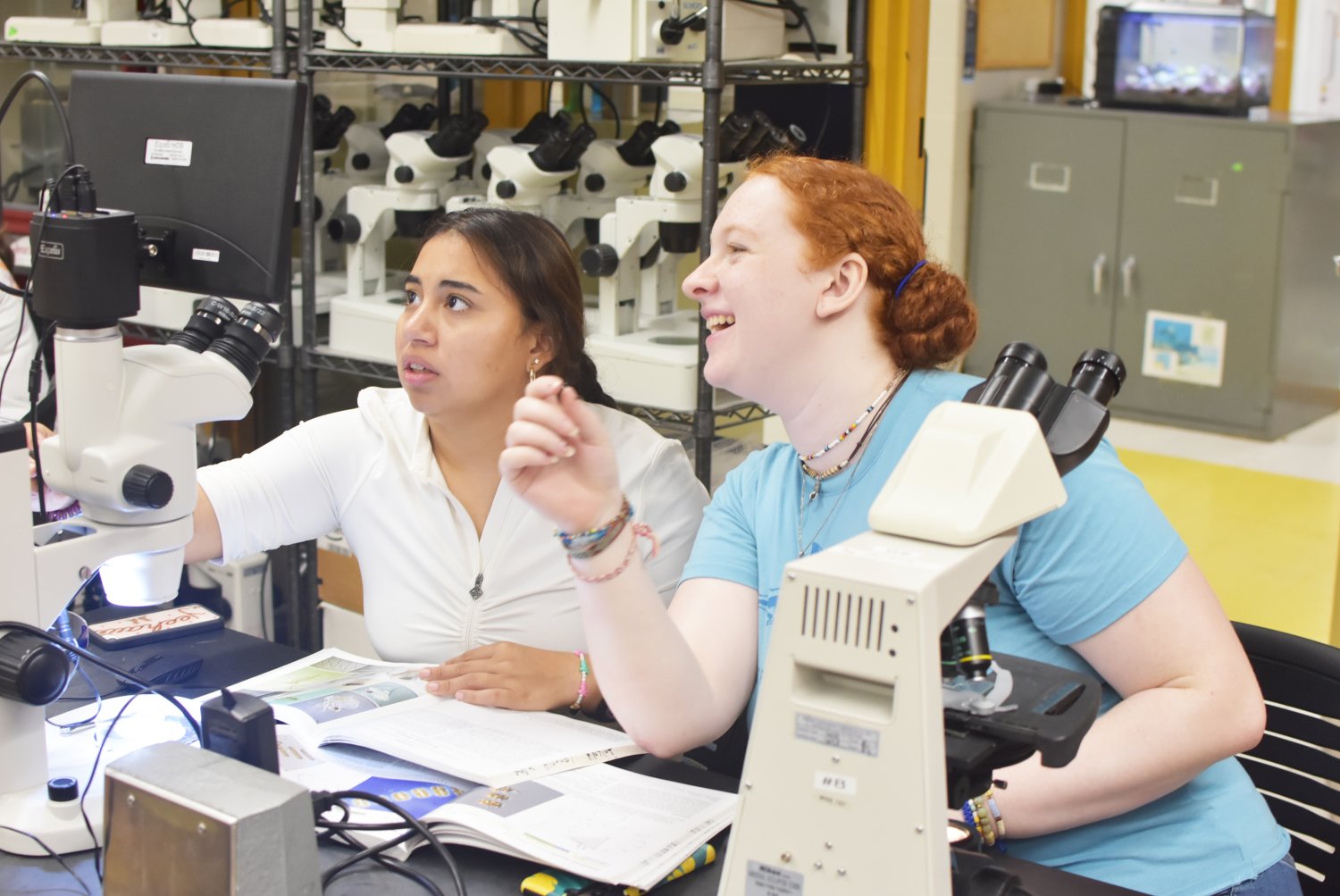 Two Marine Biology Summer Camp students examine marine specimens collected at Fogland Beach.