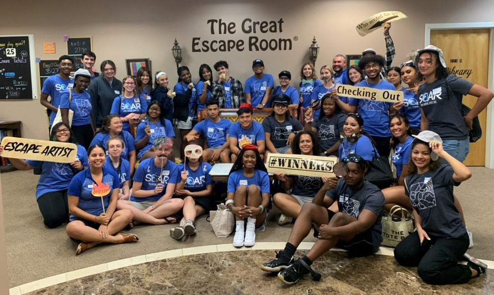 group picture of students in the lobby of an escape room center