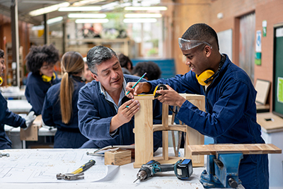 A student and teacher work on a project