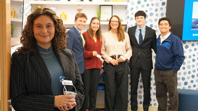 Professor Amiee Shelton and PR students standing in the new PR lab on campus