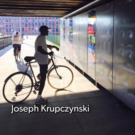 A photo of a man on a bicycle viewing the installation art in a tunnel