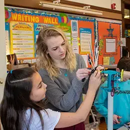 Student works with children at an elementary school