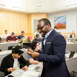 Professor smiles in front of class