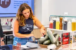 Student cooking at a prep your own station