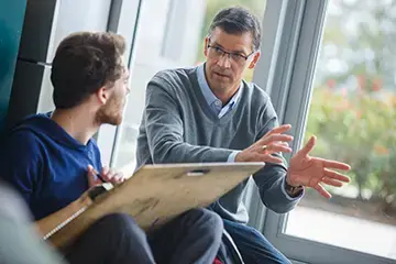 Student and professor discussing work.