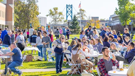 Attendees at Saturday's Autumn Festival enjoy a lively atmosphere as they engage in friendly games and savor delicious offerings from local vendors.