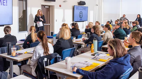 Guests listening to symposium lecture.