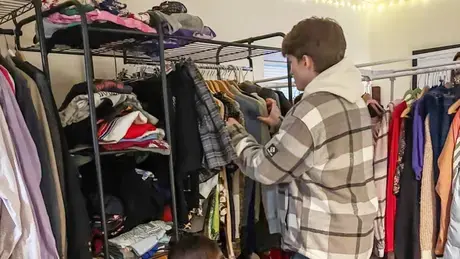 Student browses rack in RWU's new thrift center.