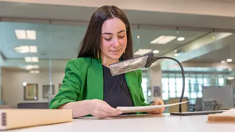 Rachel Cabral holds the Freedom Seeker document.