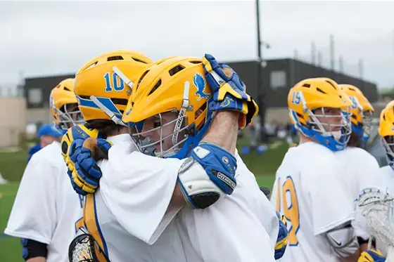 Athletic team embracing.