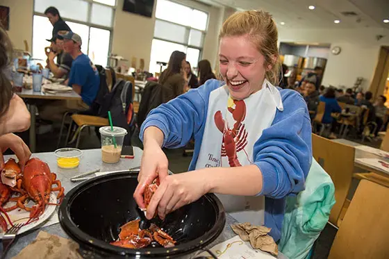 Student eating lobster.