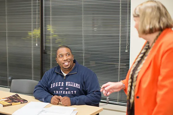 A faculty member speaks with a student.