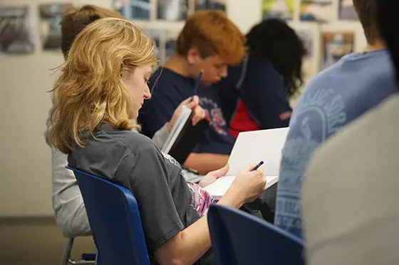 Students writing in notebooks