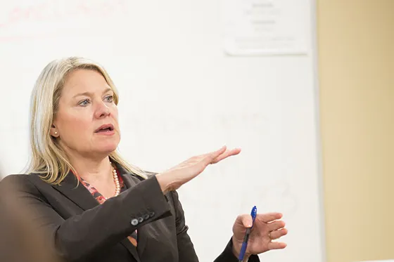 A faculty member lectures.