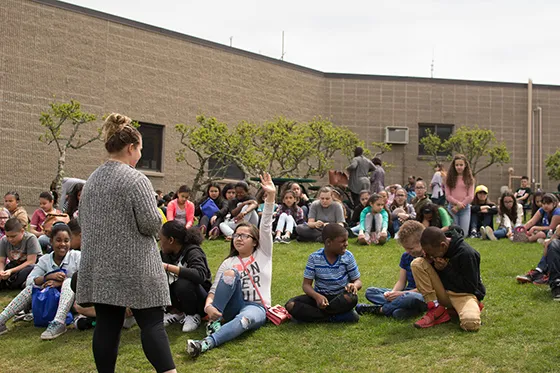 A student presents to a class of fifth graders