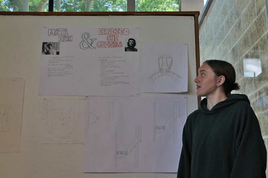 A student presenting her drawings