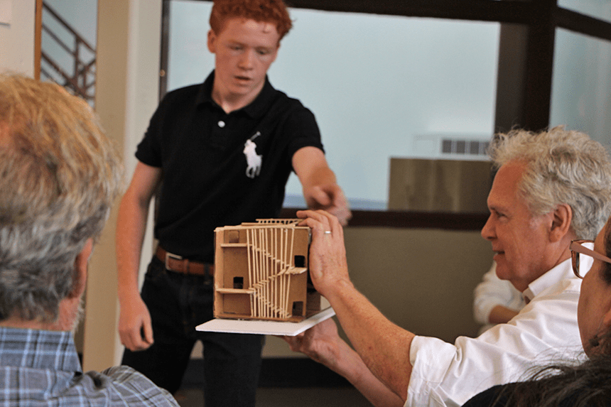 Dean White and a student discussing a model