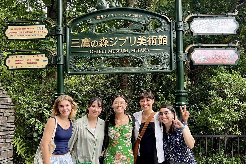 Students pose with Ghibili museum sign