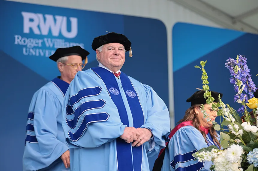 RWU faculty stand on stage