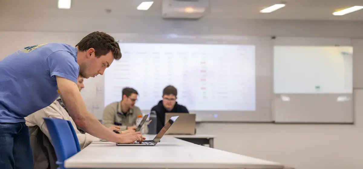 Student with a computer in a classroom