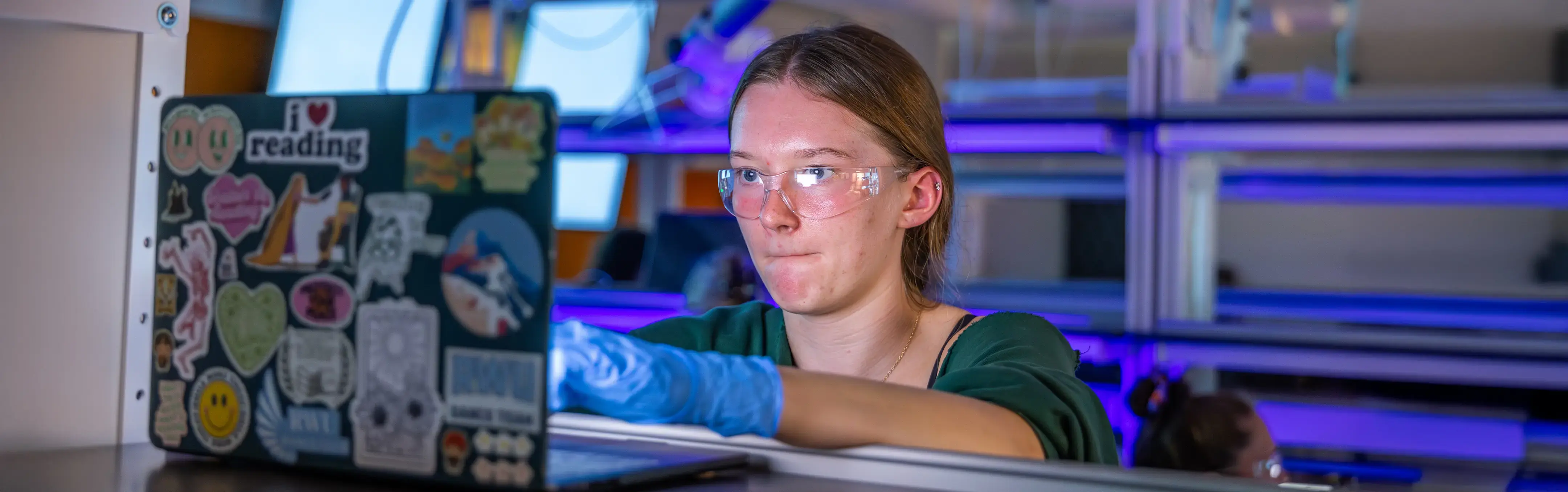 A grad student attempts to unlock a criminal's laptopn in a laboratory setting