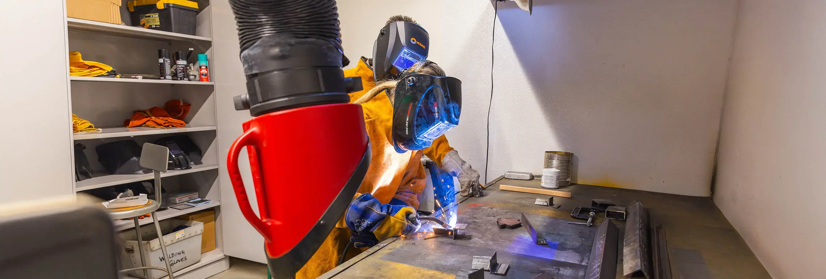 Welders work on a project in a workshop