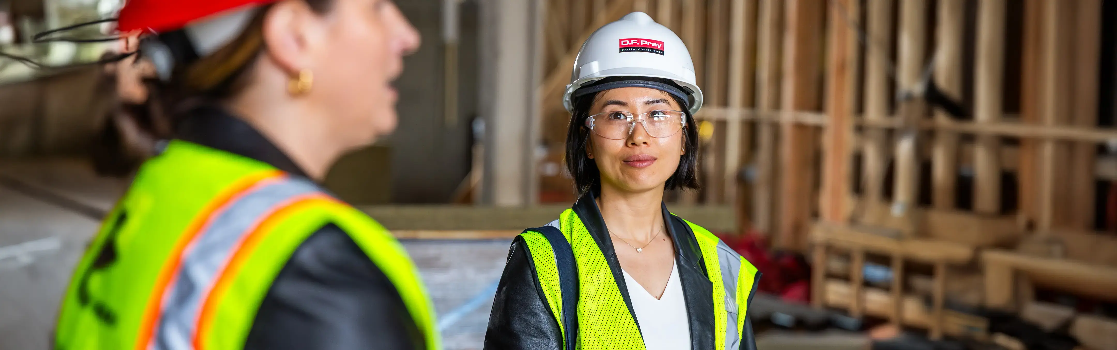 A project manager listens to a meeting at a construction site
