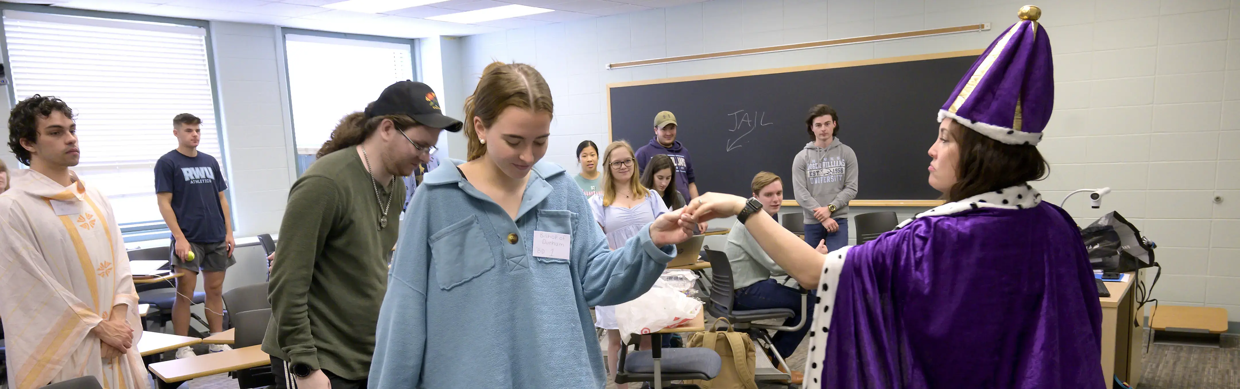A professor role plays with students in a classroom