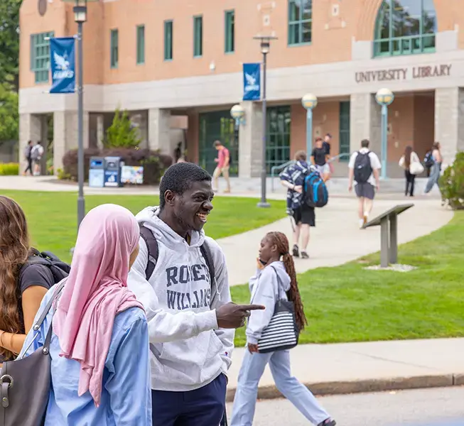 Students on campus in front of RWU library