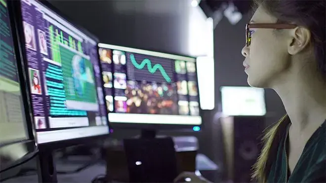 Person looking at computer monitors that are displaying crime analytics